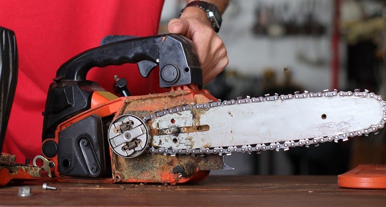 cleaning of the small chainsaw by a person